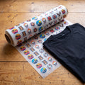 Rulle med DTF-transferfilm, 58 cm bred, bredvid en t-shirt